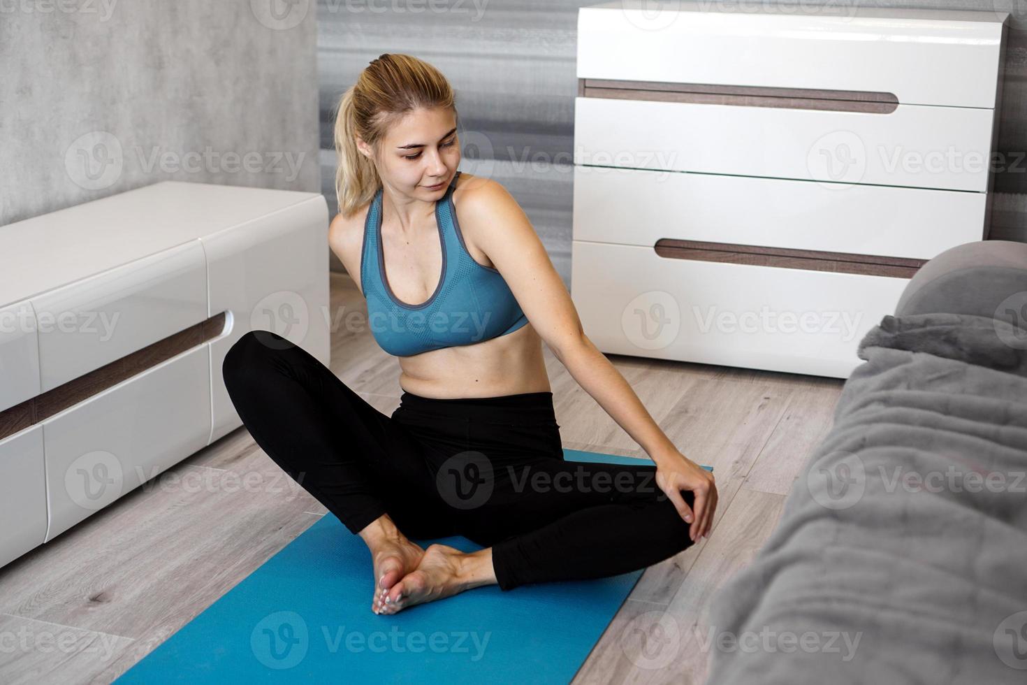 Happy fitness woman yoga relax meditation in butterfly pose at home. photo