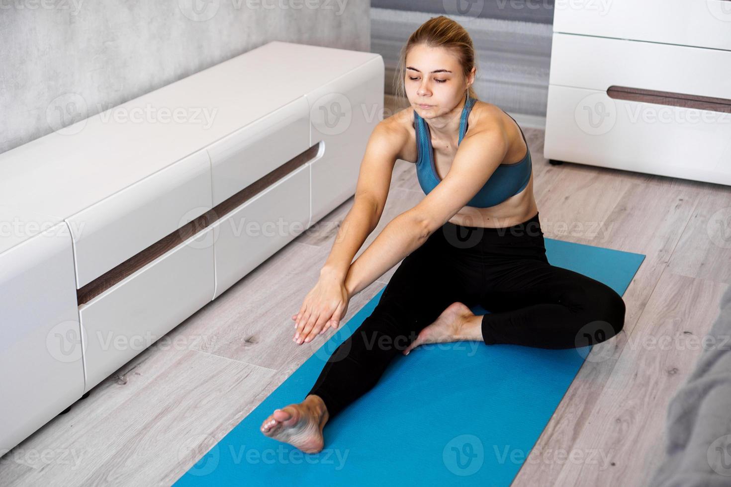 Sport, training and lifestyle concept - woman stretching photo