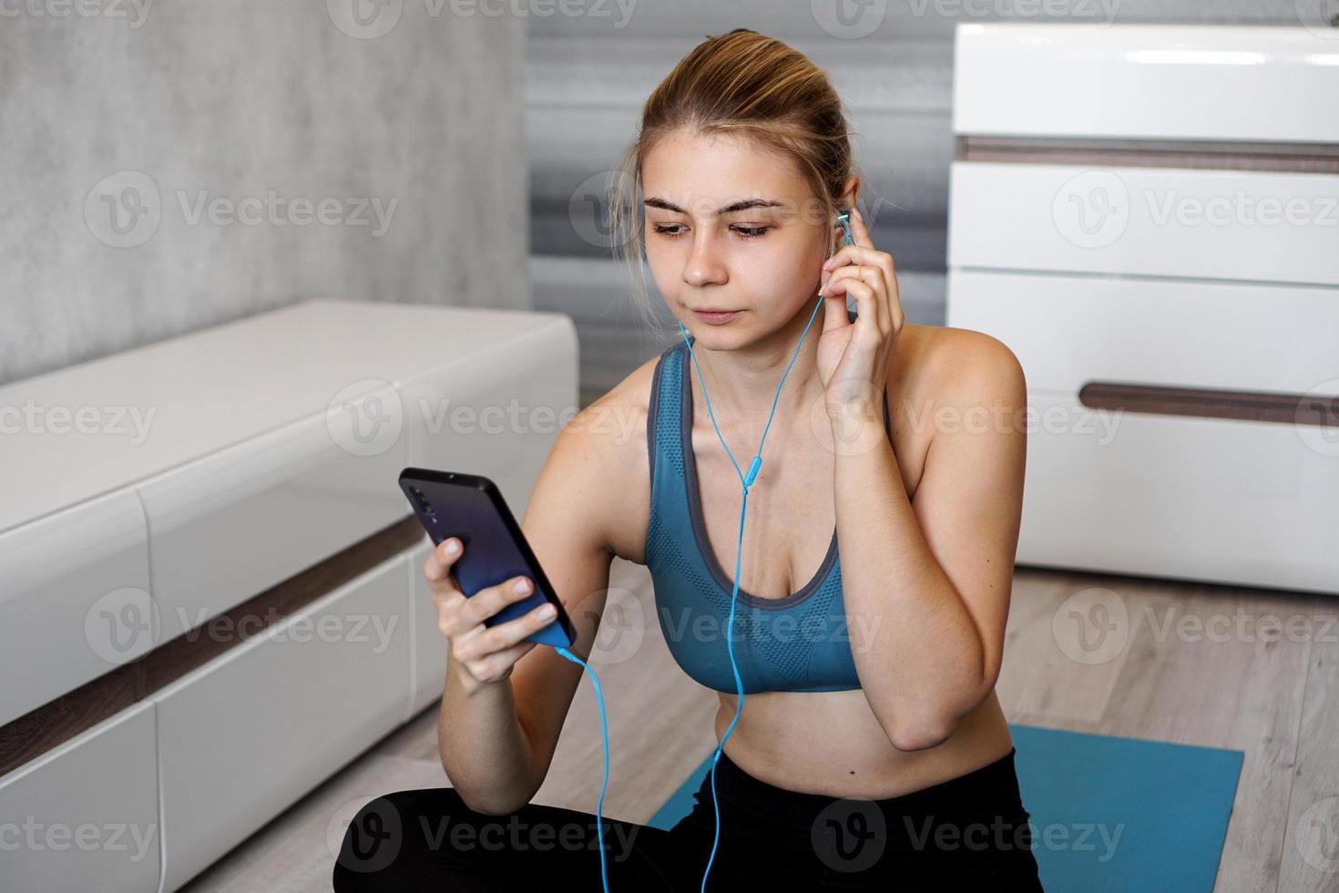Sport woman with earphones enjoying the music playing photo
