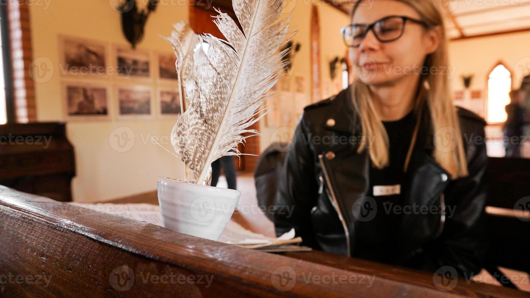 White quill and inkwell in the old university auditorium. photo