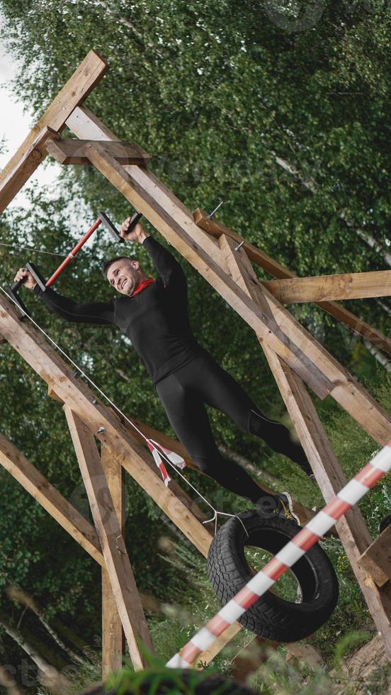 Man passing through hurdles during obstacle course in boot camp photo