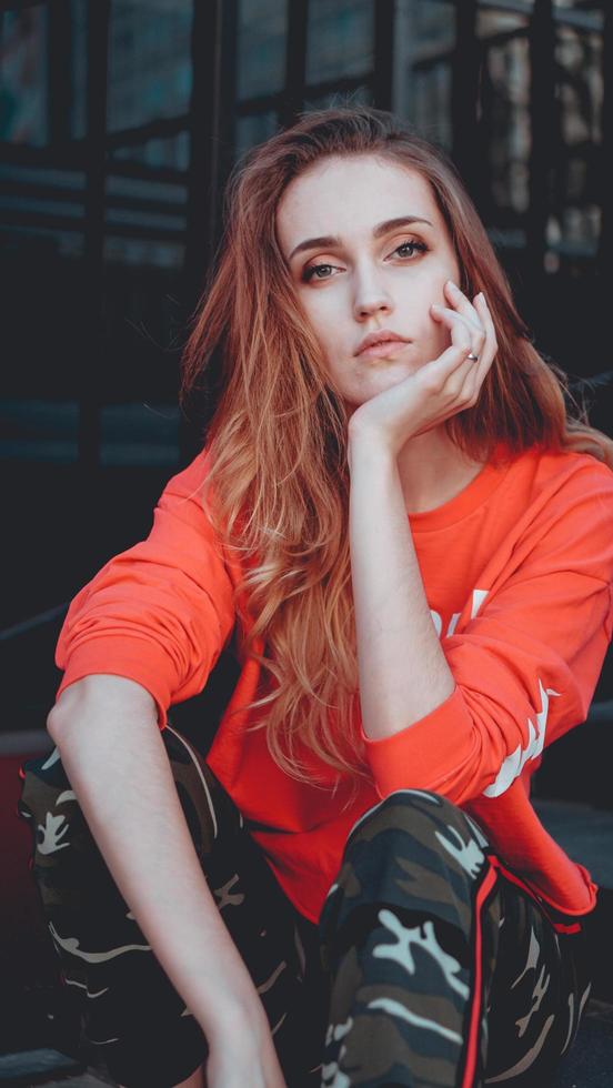 Fashion model wearing red hoodie with inscription los angeles photo