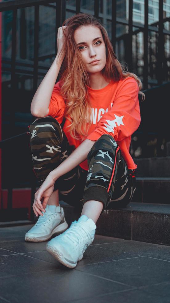 Fashion model wearing red hoodie with inscription los angeles photo