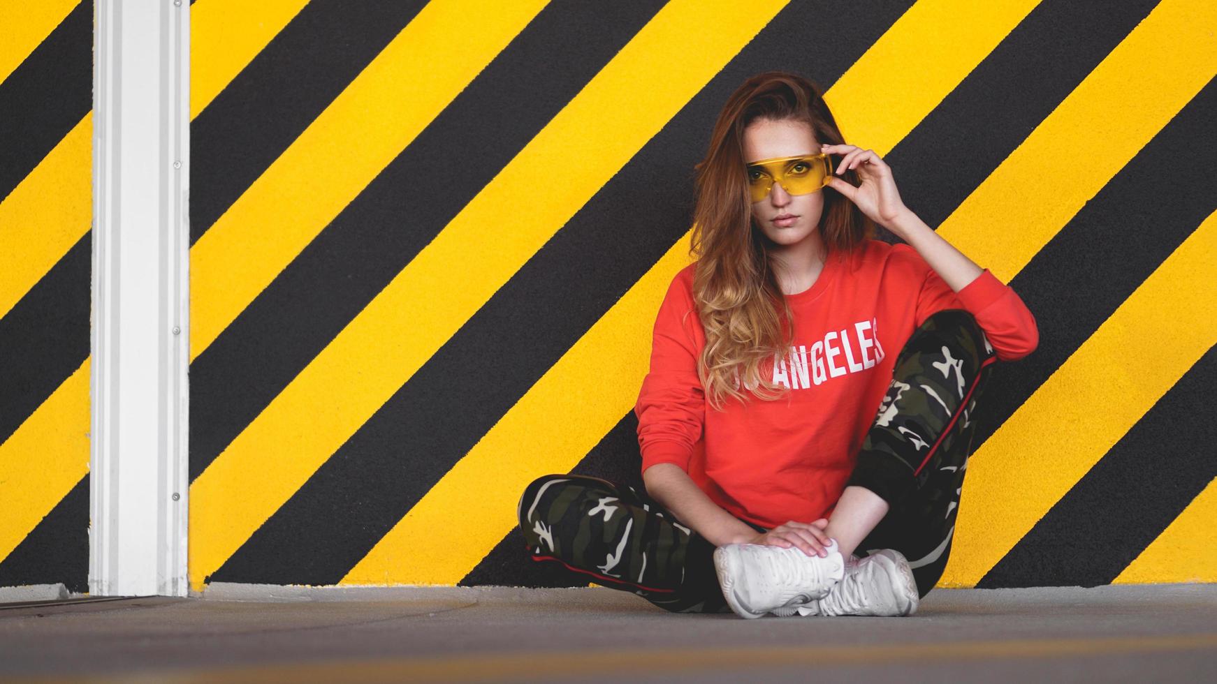 Fashion model wearing red hoodie with inscription los angeles photo