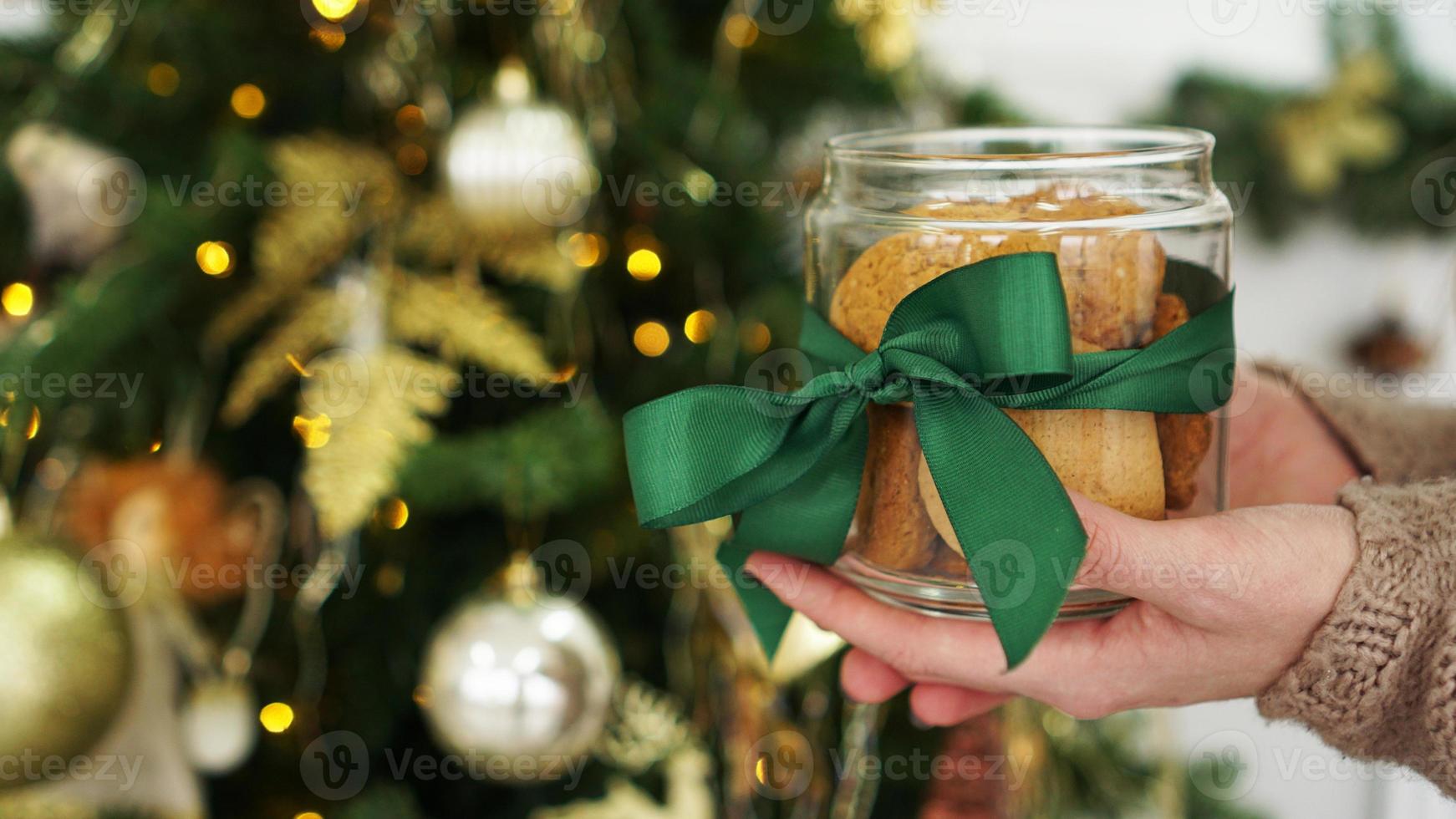 Oat cookies in a glass jar. Against the background of Christmas decor photo