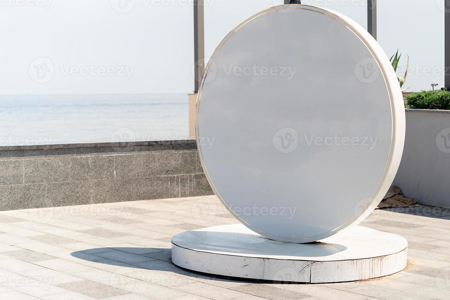 Blank white sign for logo located by the sea on the embankment photo