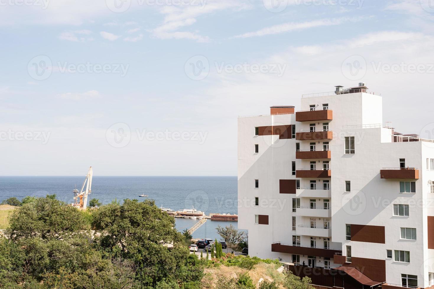 Modern hotel or apartment building on the seaside photo
