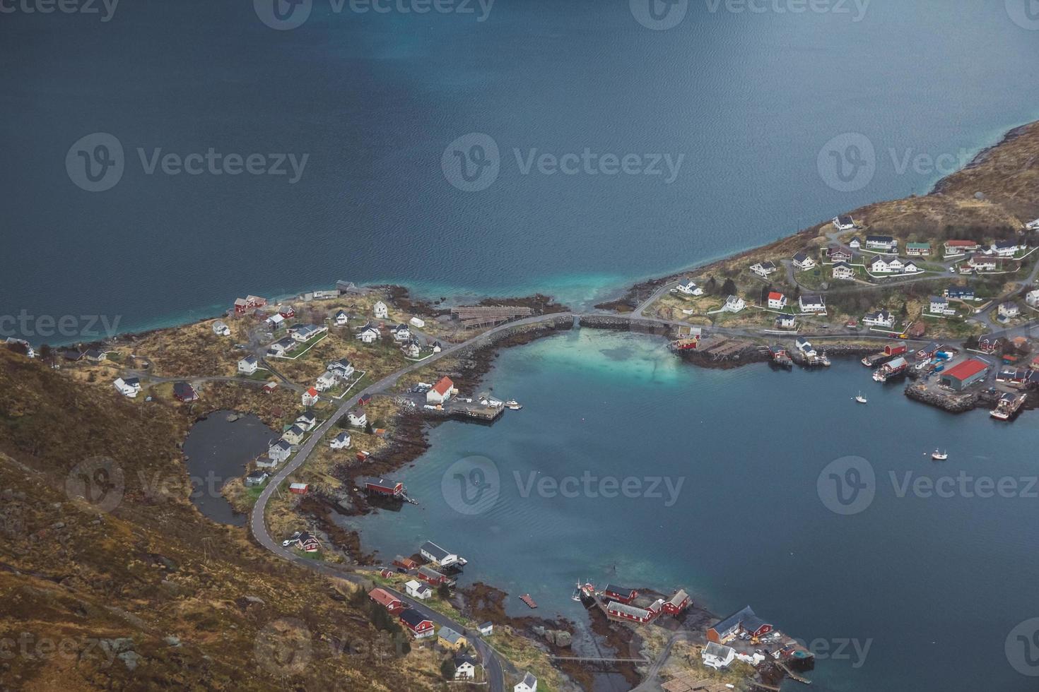 Scenic landscape of Lofoten islands peaks, lakes, and houses photo