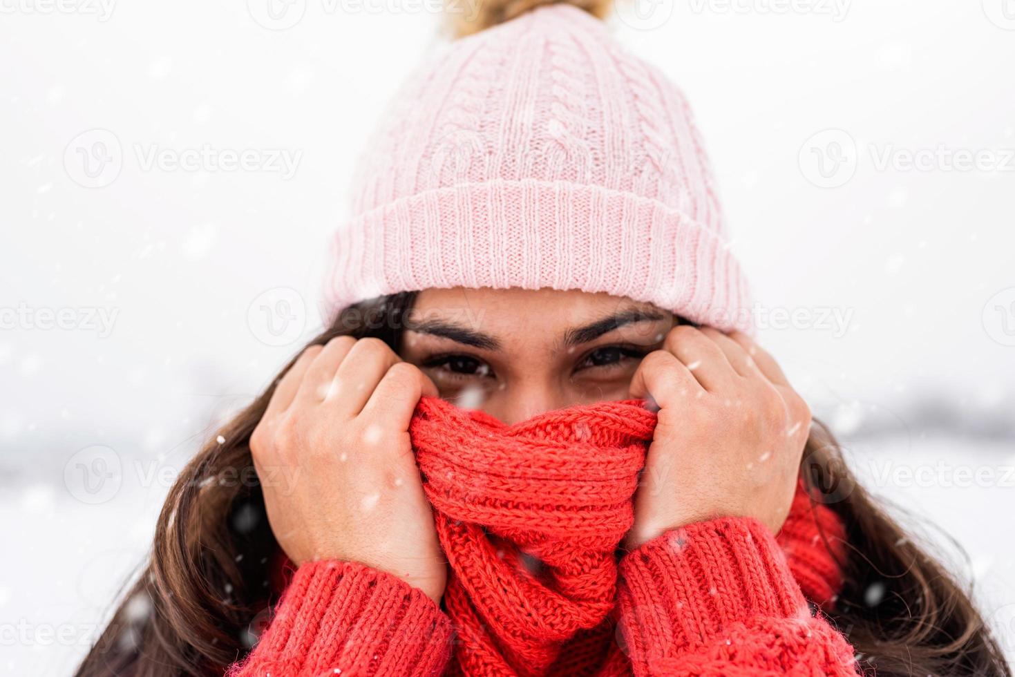 Portrait of a beautiful smiling young woman in wintertime outdoors photo