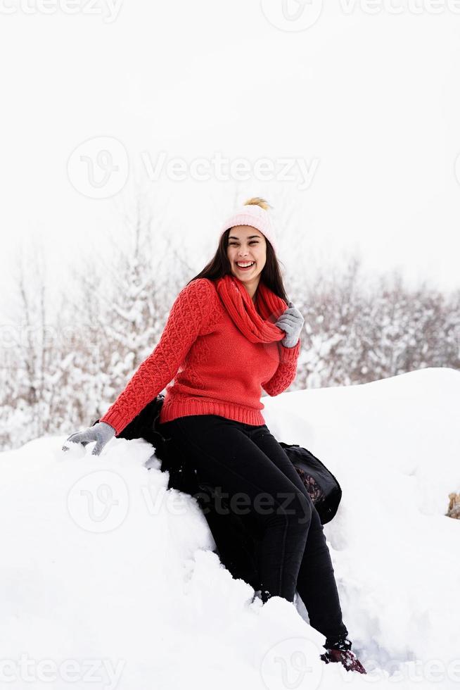 Portrait of a beautiful smiling young woman in wintertime outdoors photo