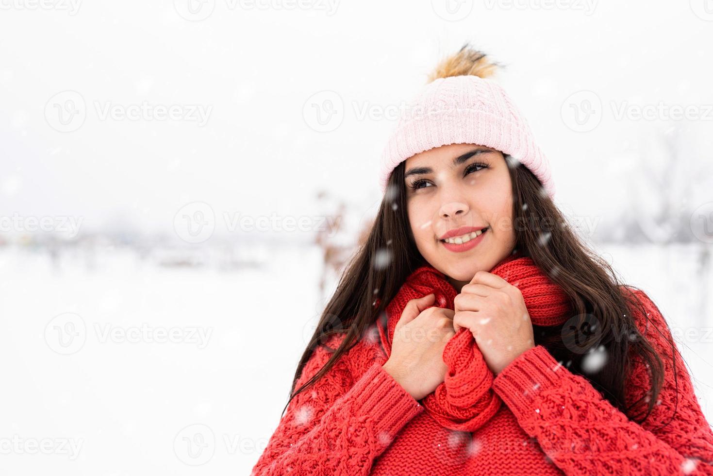 Portrait of a beautiful smiling young woman in wintertime outdoors photo