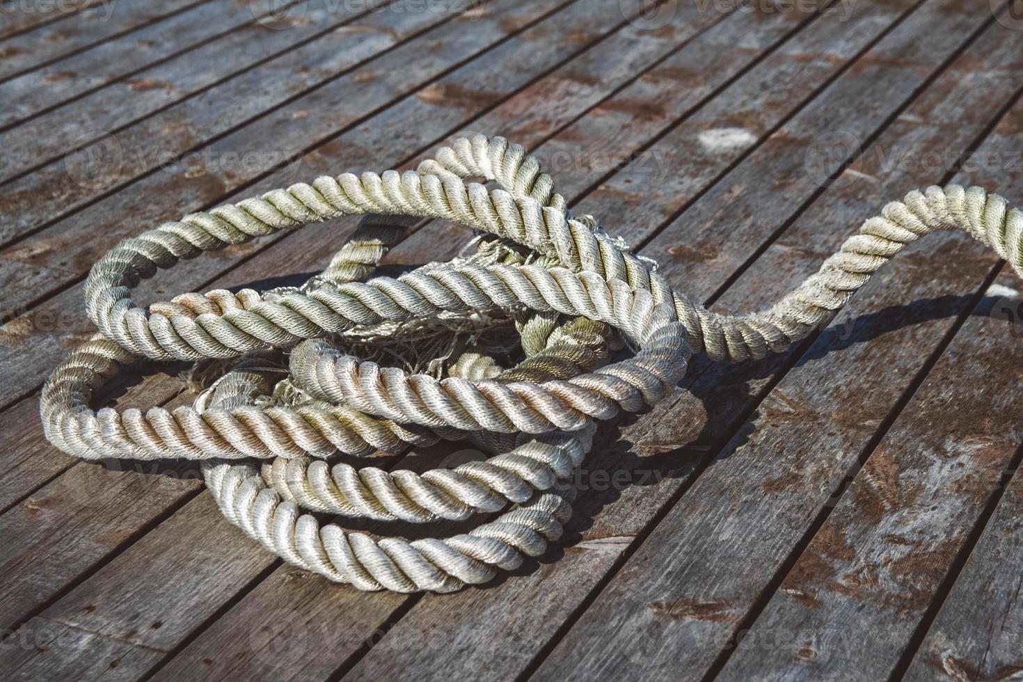 Mooring rope on wooden pier photo