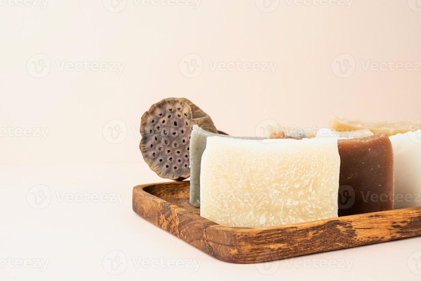 Stack of hand made soap with lotus on beige background photo