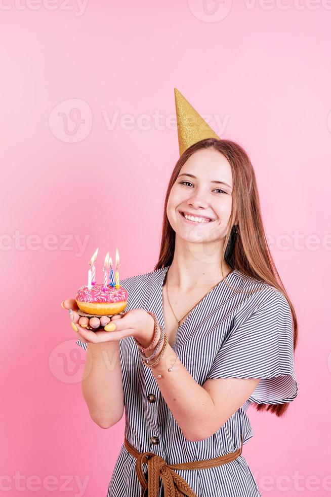 adolescente, niña, tenencia, donut, con, vela foto