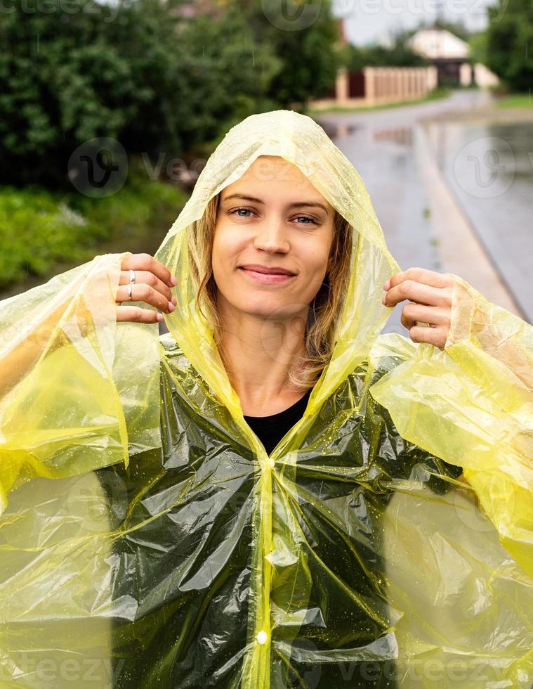 Beautiful happy caucasian woman enjoying the rain photo