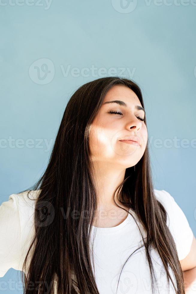 Brunette woman with reflection from light prism on her face photo