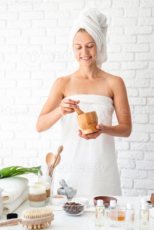Woman in white bath towel doing spa procedures photo