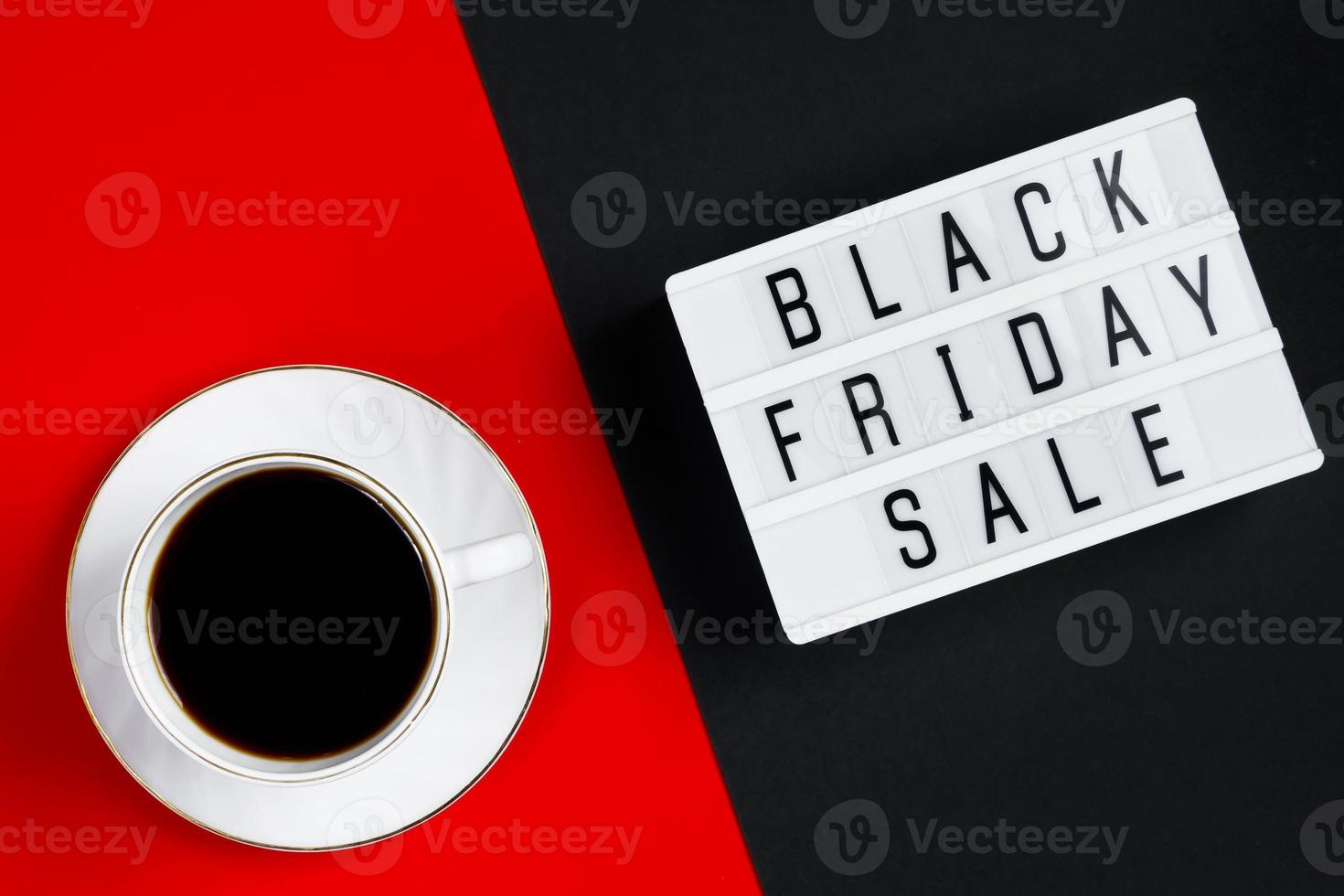 Black Friday sale concept. Cup of coffee on red background. photo