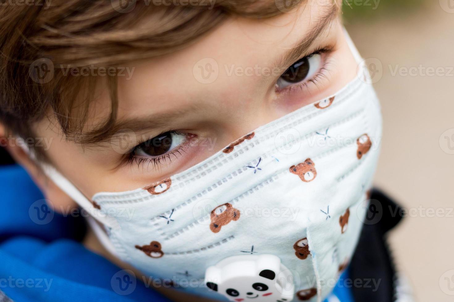 Close-up of child wearing kn95 face mask due to coronavirus pandemic. photo