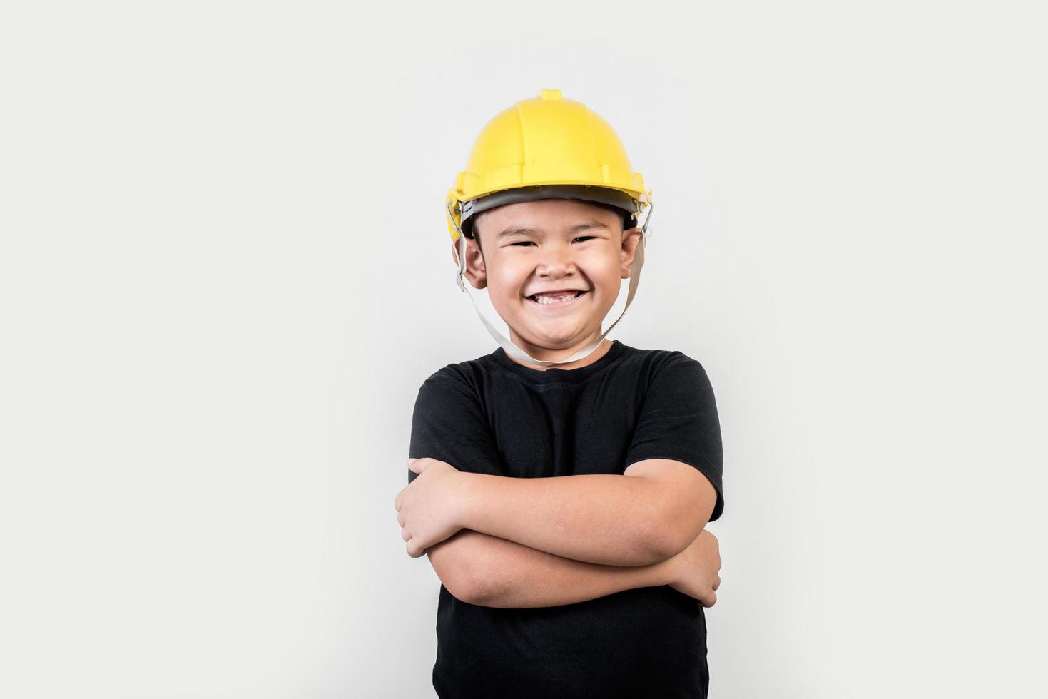 Portrait Happy boy wearing engineer hat photo