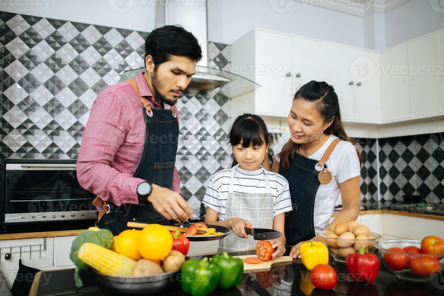 Happy family help cooking meal together in kitchen at home. photo