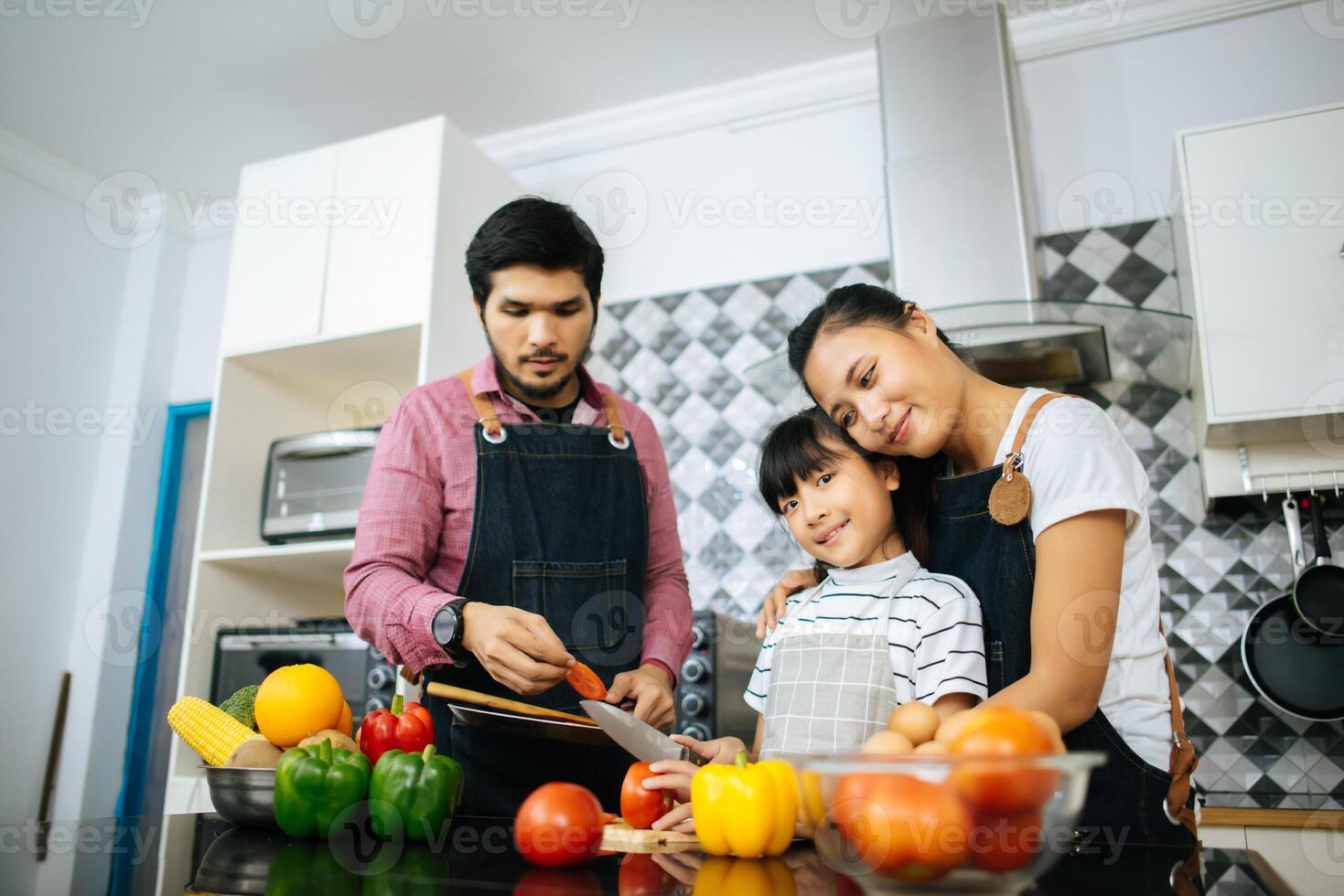 Happy family help cooking meal together in kitchen at home. photo