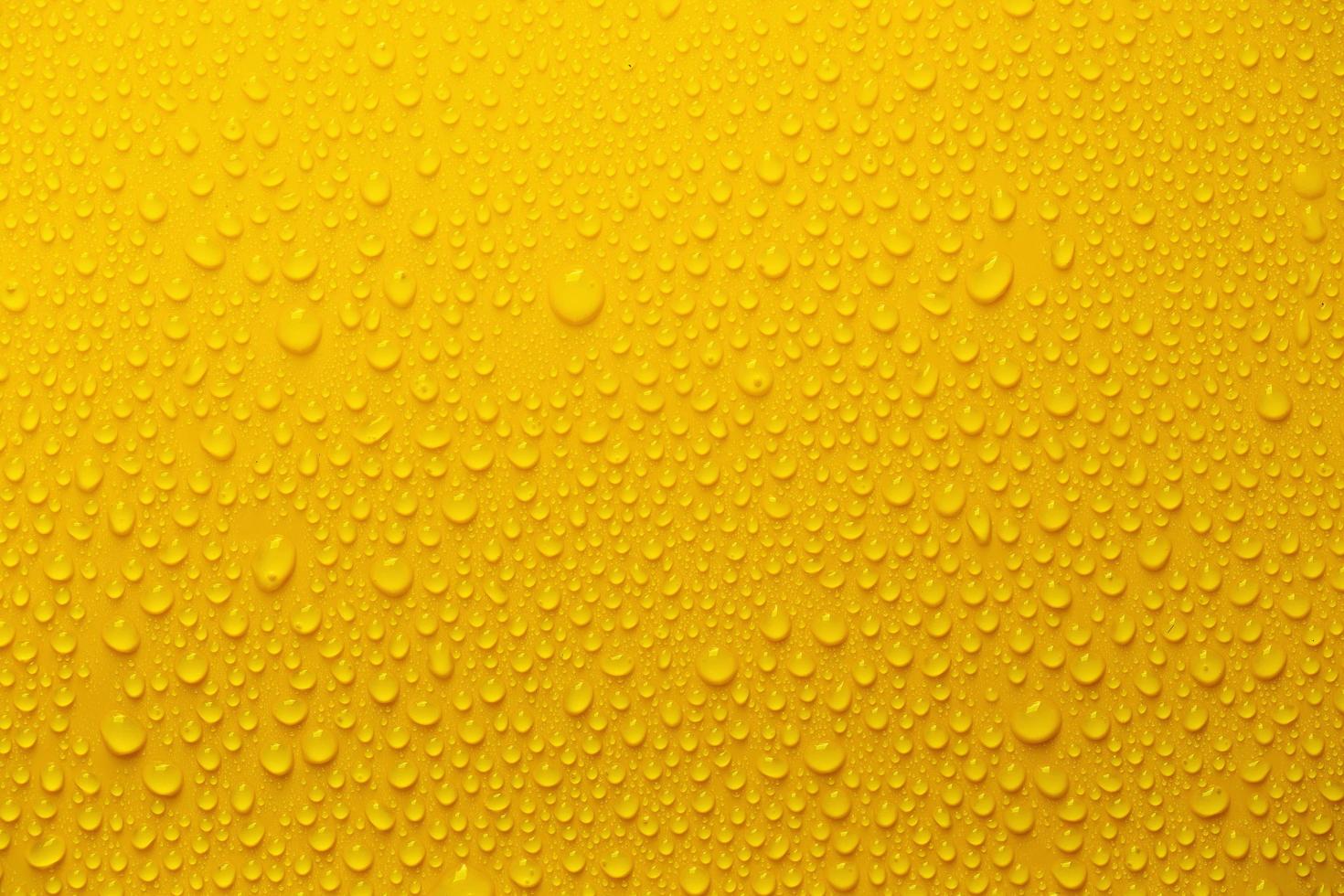 Rain or Water drops on yellow background photo