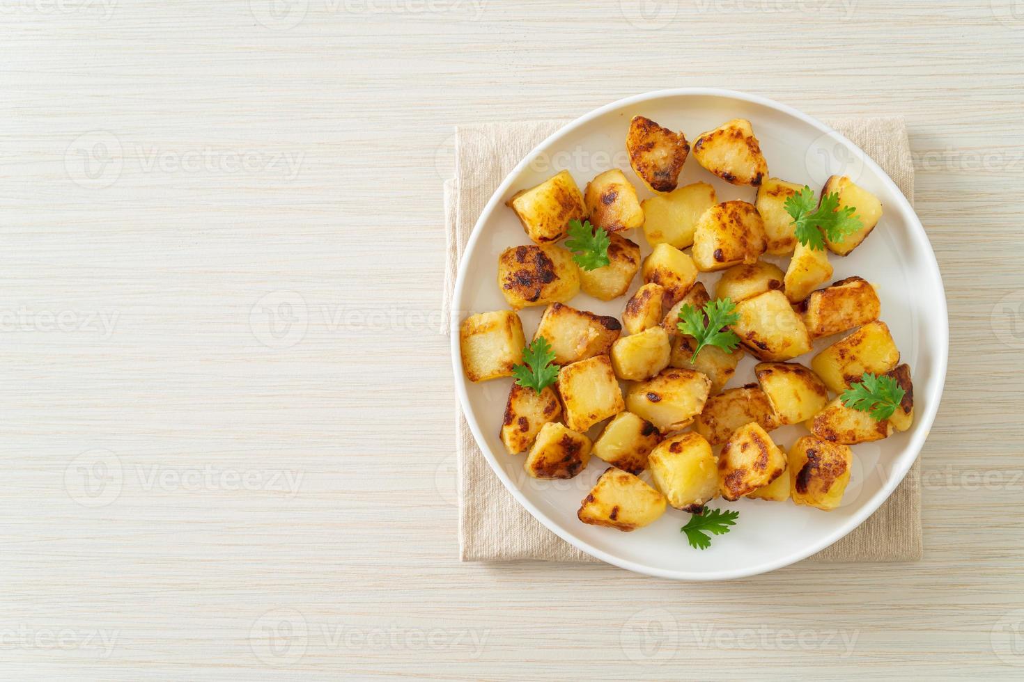 Roasted or grilled potatoes  on plate photo