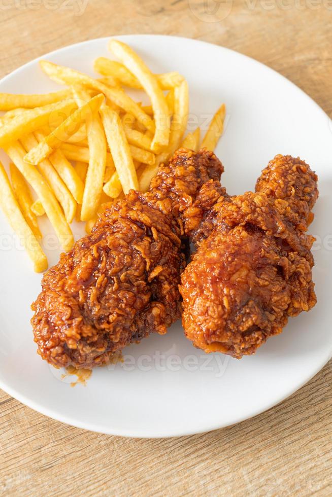 Spicy Korean fried chicken with fries photo