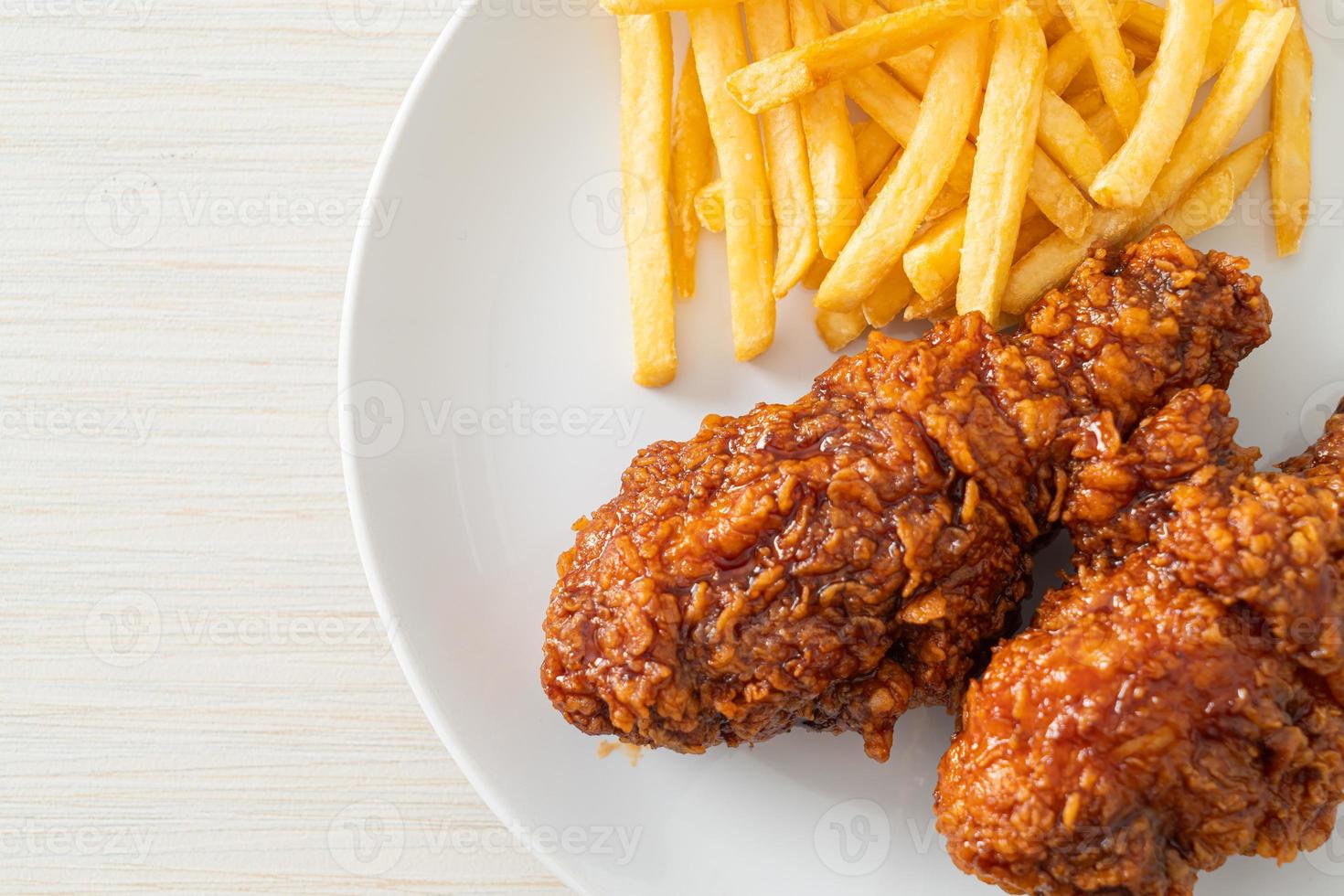 Spicy Korean fried chicken with fries photo