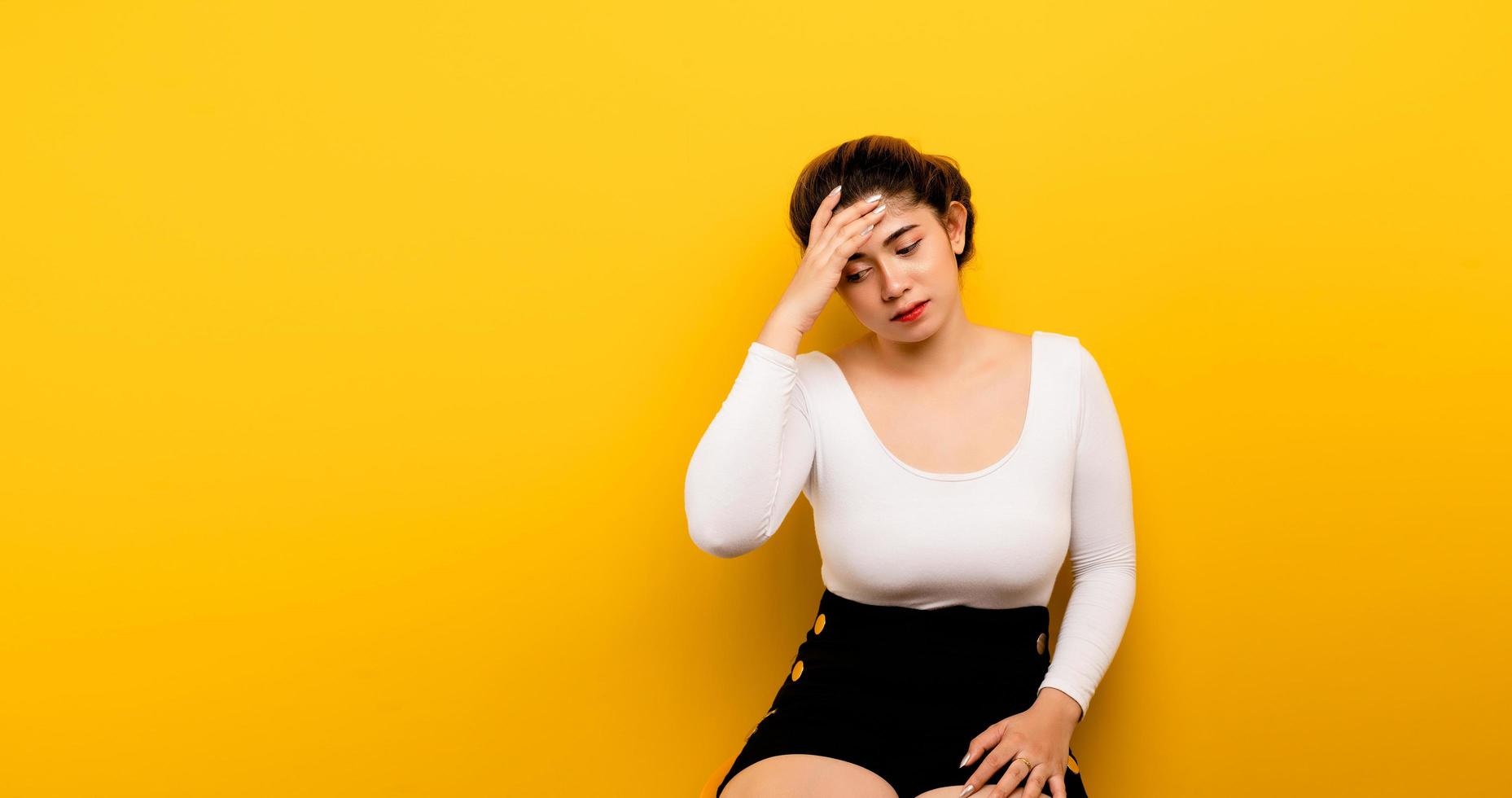 Headache Asian woman on a lonely background Who suffers from photo