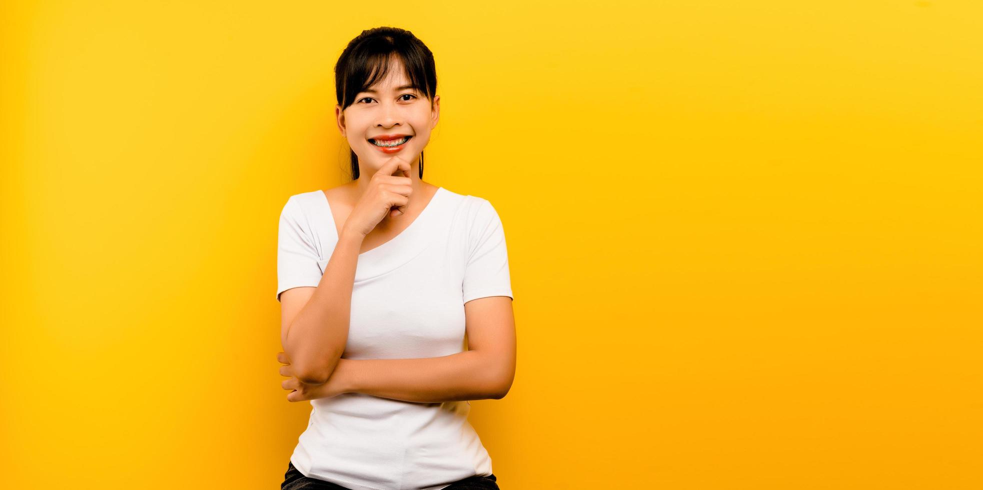 Retrato de una bella mujer asiática alegre, vestida de blanco foto