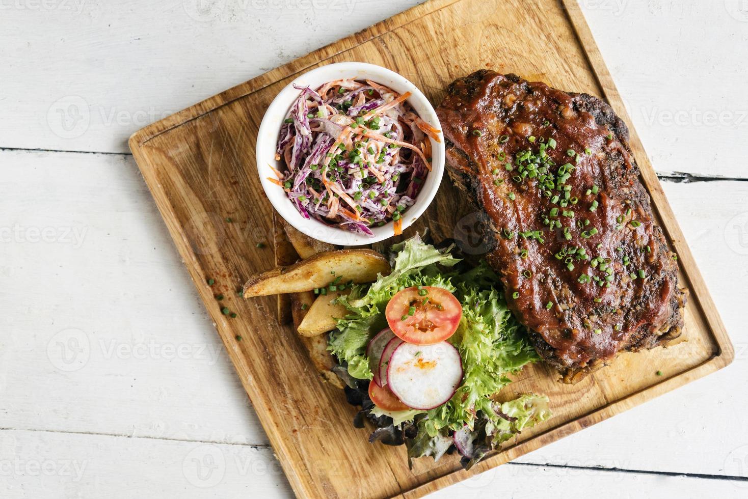 Pork bbq ribs with coleslaw and salad set meal photo