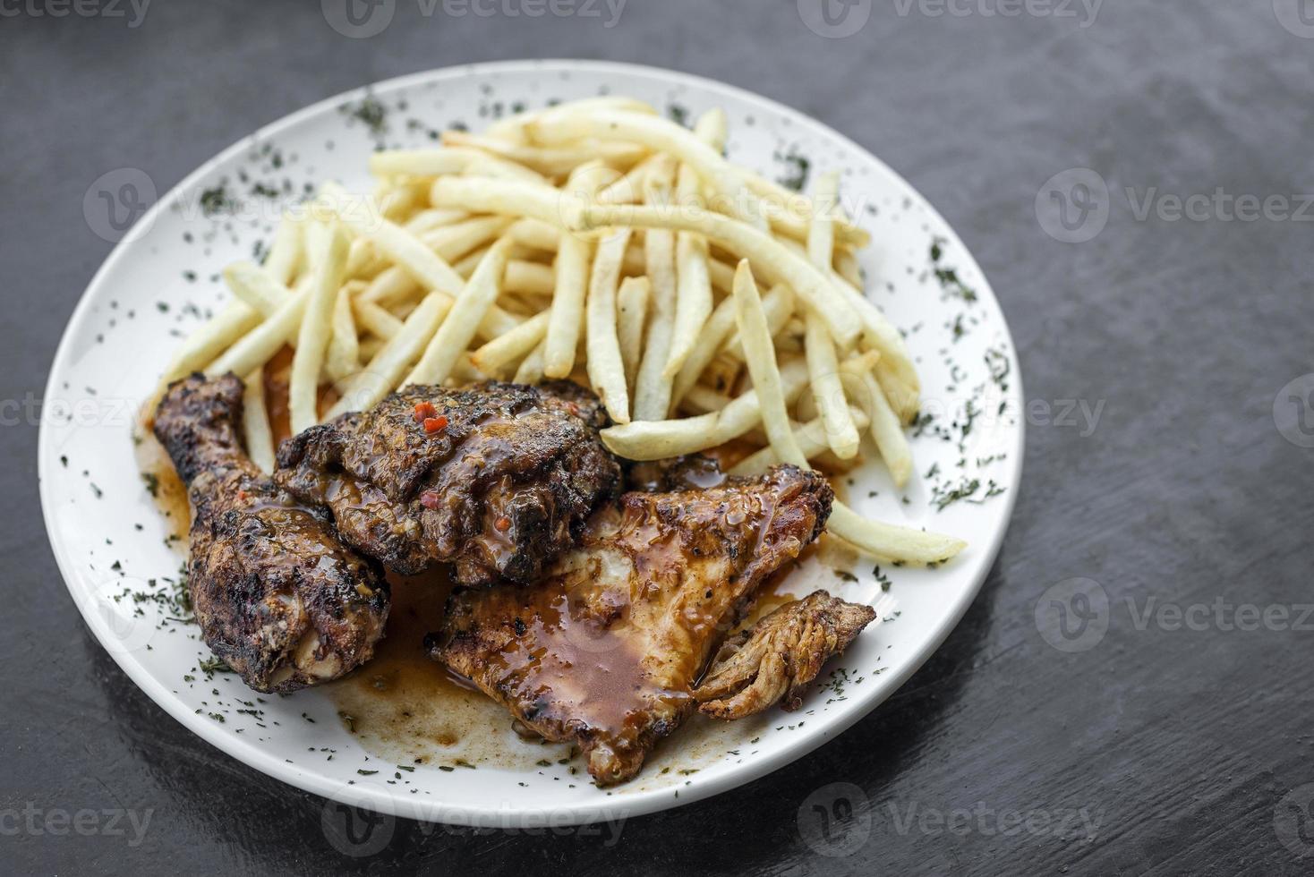 Portuguese famous piri piri spicy bbq chicken with french fries meal photo