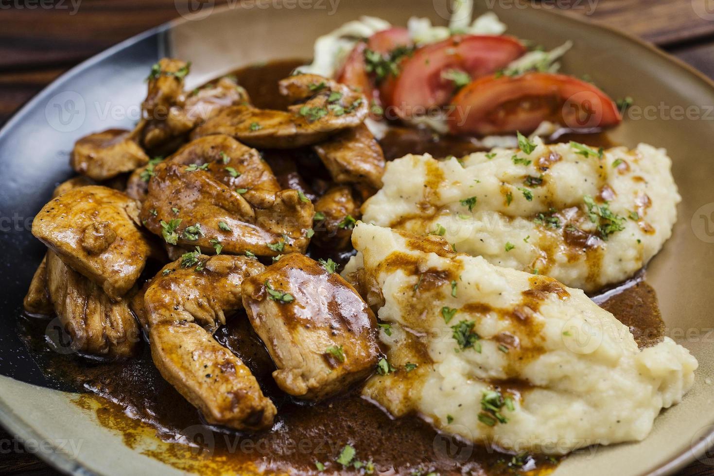 Chicken breast with brown gravy sauce and mashed potato meal photo