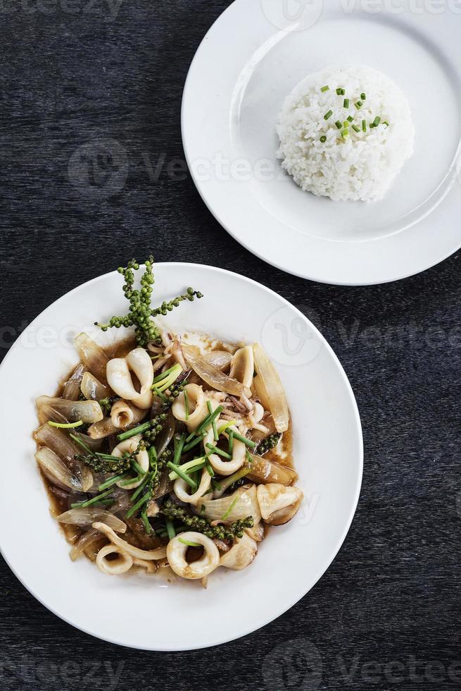 Fresh squid and Kampot green pepper stir fry traditional Asian Cambodian seafood meal photo