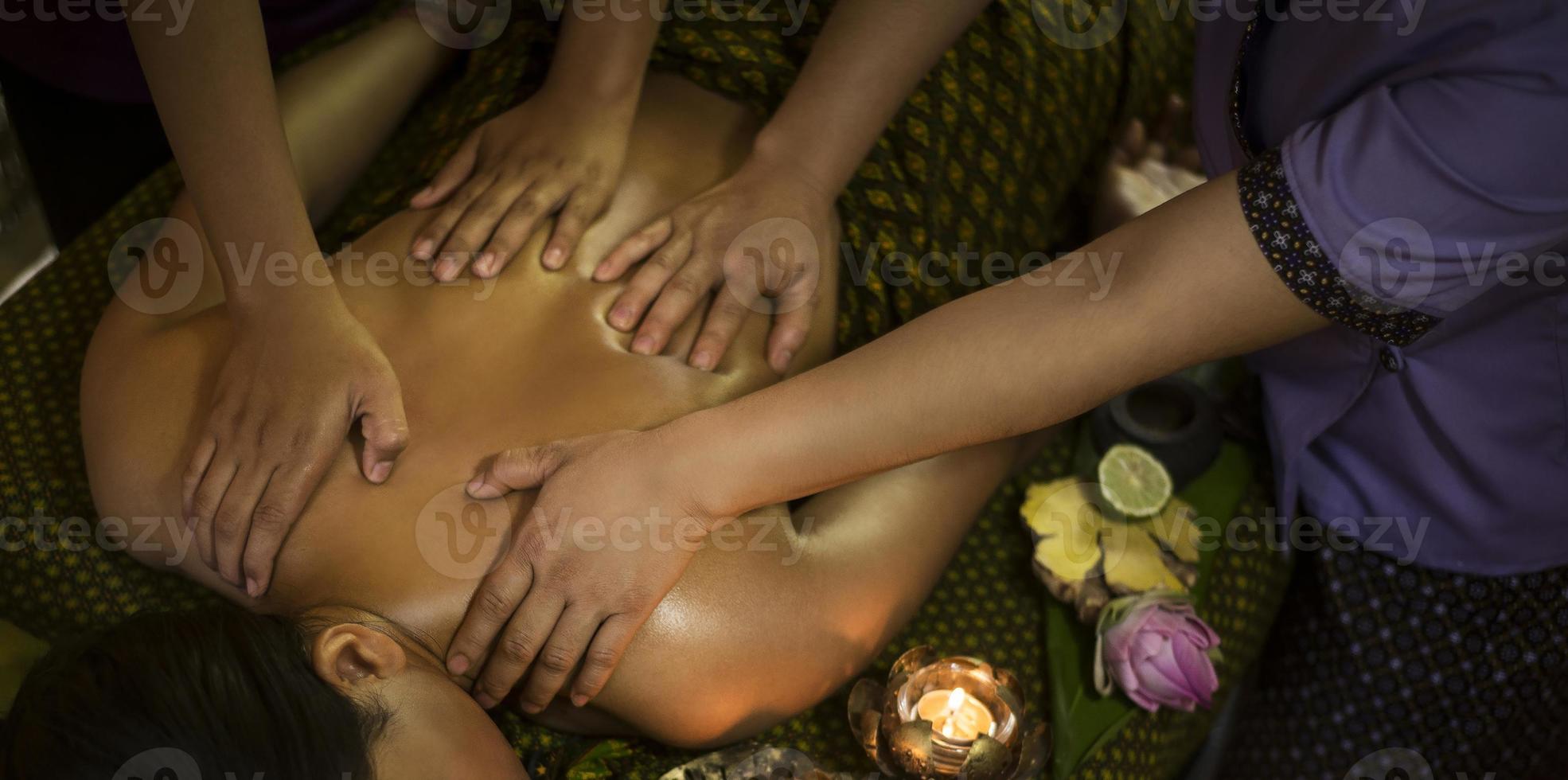 Traditional Asian Thai four hand massage in tropical spa detail photo