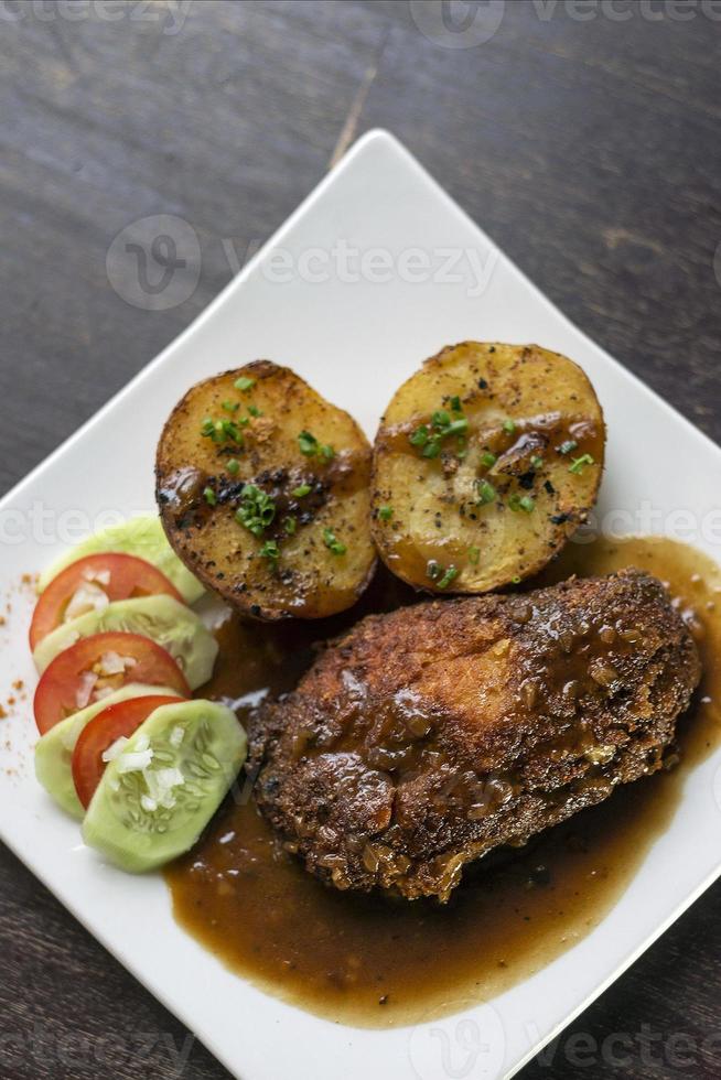 Famous cordon bleu breaded fried chicken gravy and potatoes meal photo