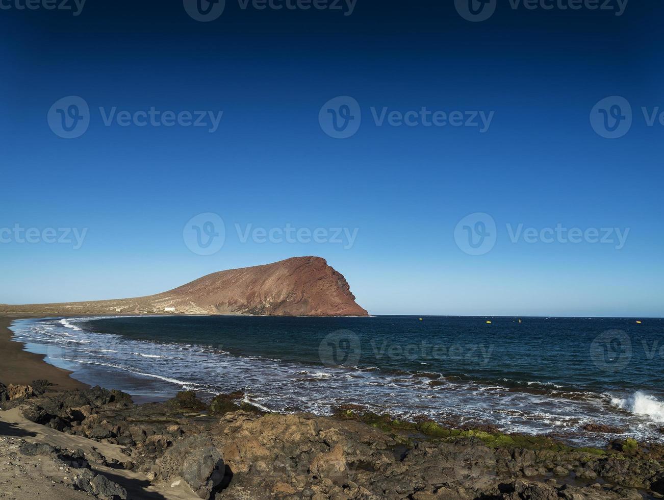 La Tejita kite surfing beach and Montana Roja landmark in south Tenerife Spain photo