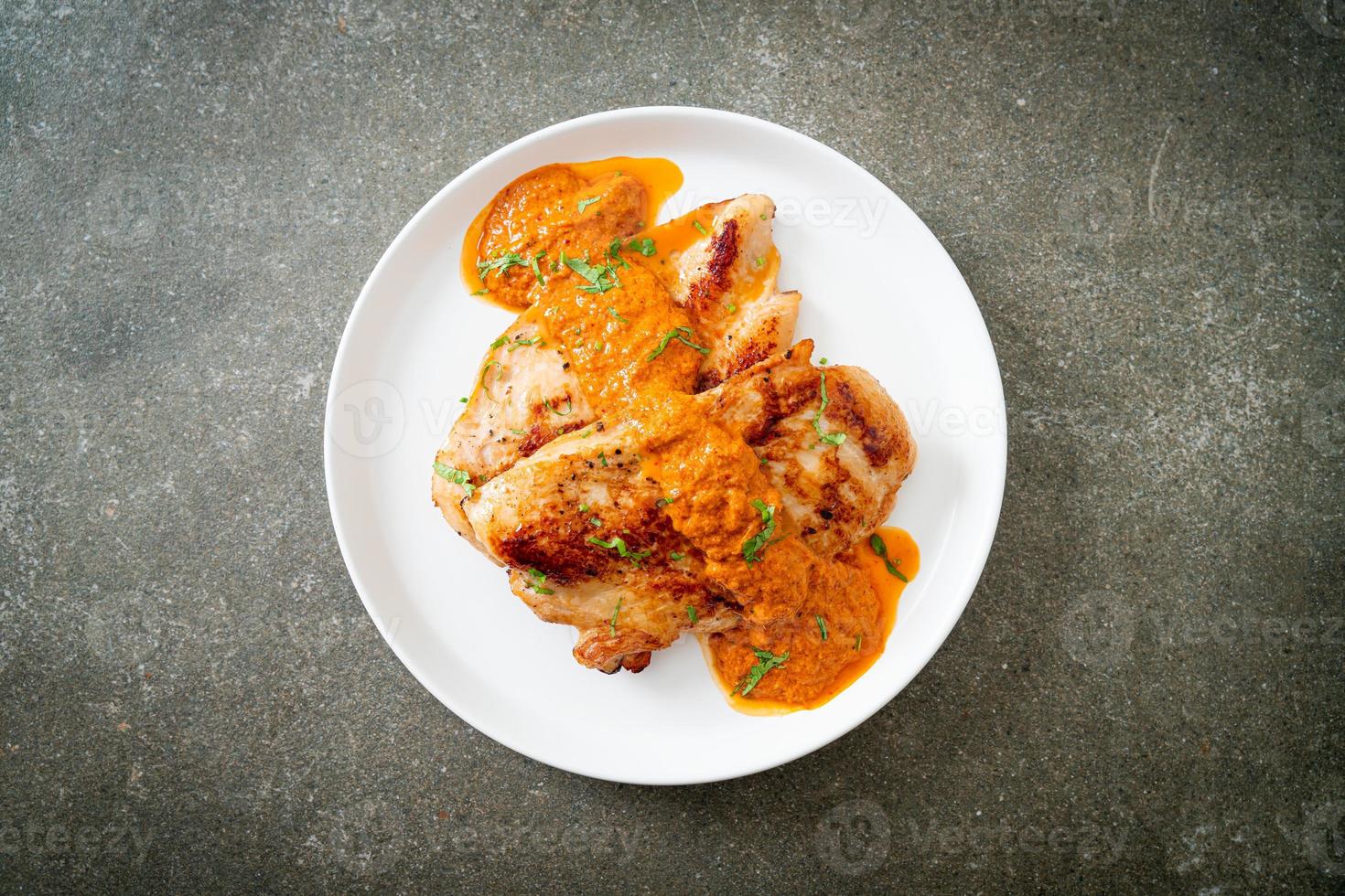 Grilled chicken steak with red curry sauce and rice photo