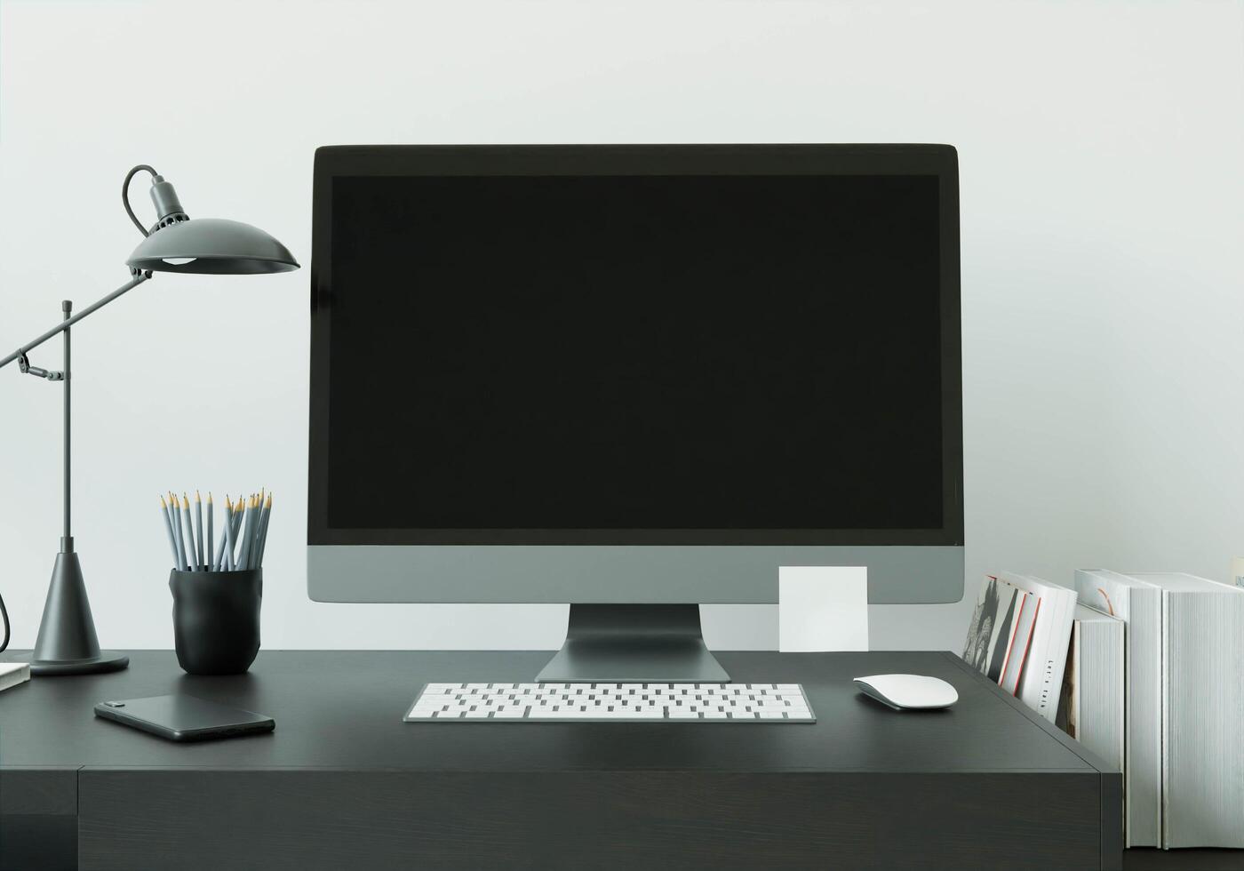 una sala de trabajo con una computadora colocada sobre la mesa foto