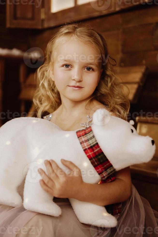 Little baby girl toddler sitting with white polar teddy bear photo