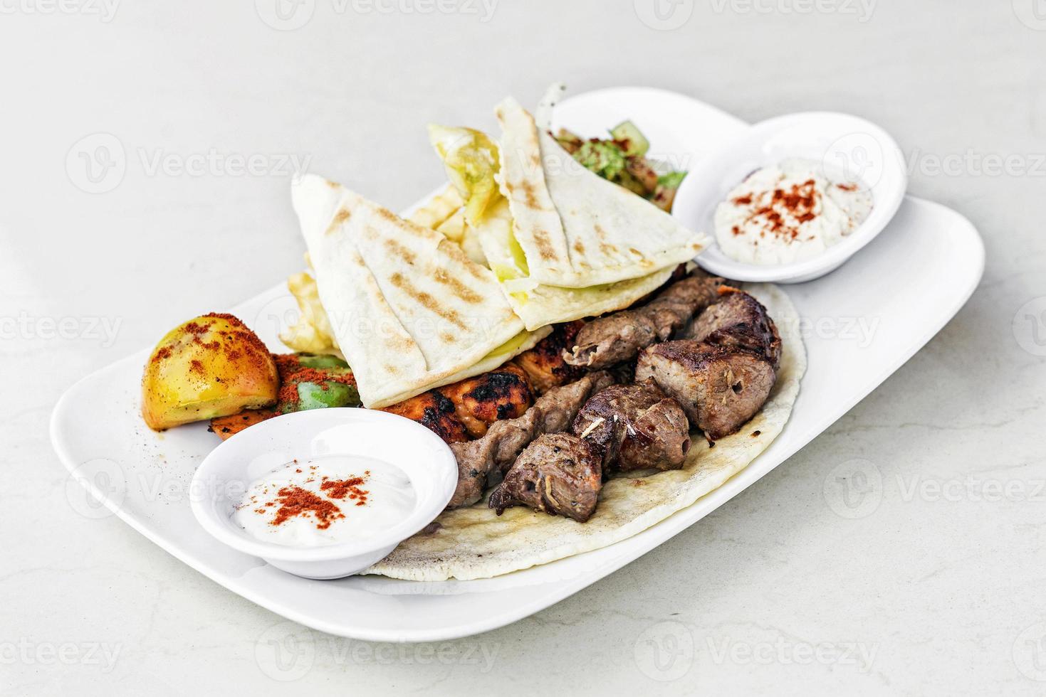 Traditional Middle Eastern food mixed BBQ barbecue grilled meat platter set meal photo