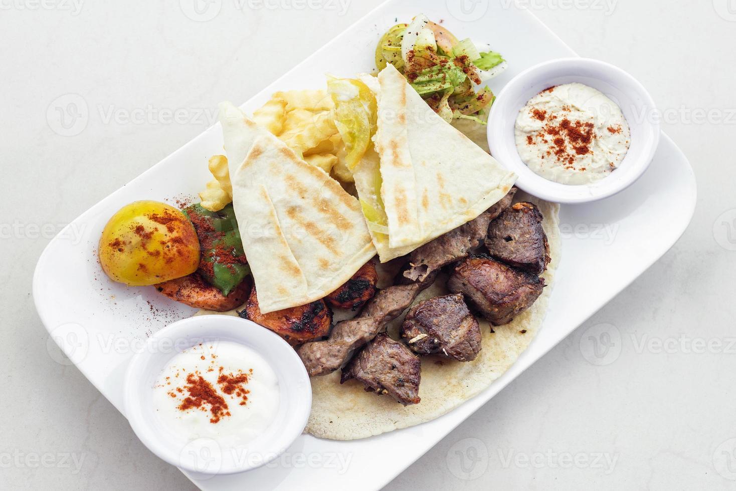 Traditional Middle Eastern food mixed BBQ barbecue grilled meat platter set meal photo