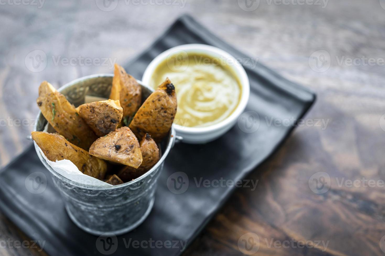 Fried potato wedges with curry sauce snack food photo