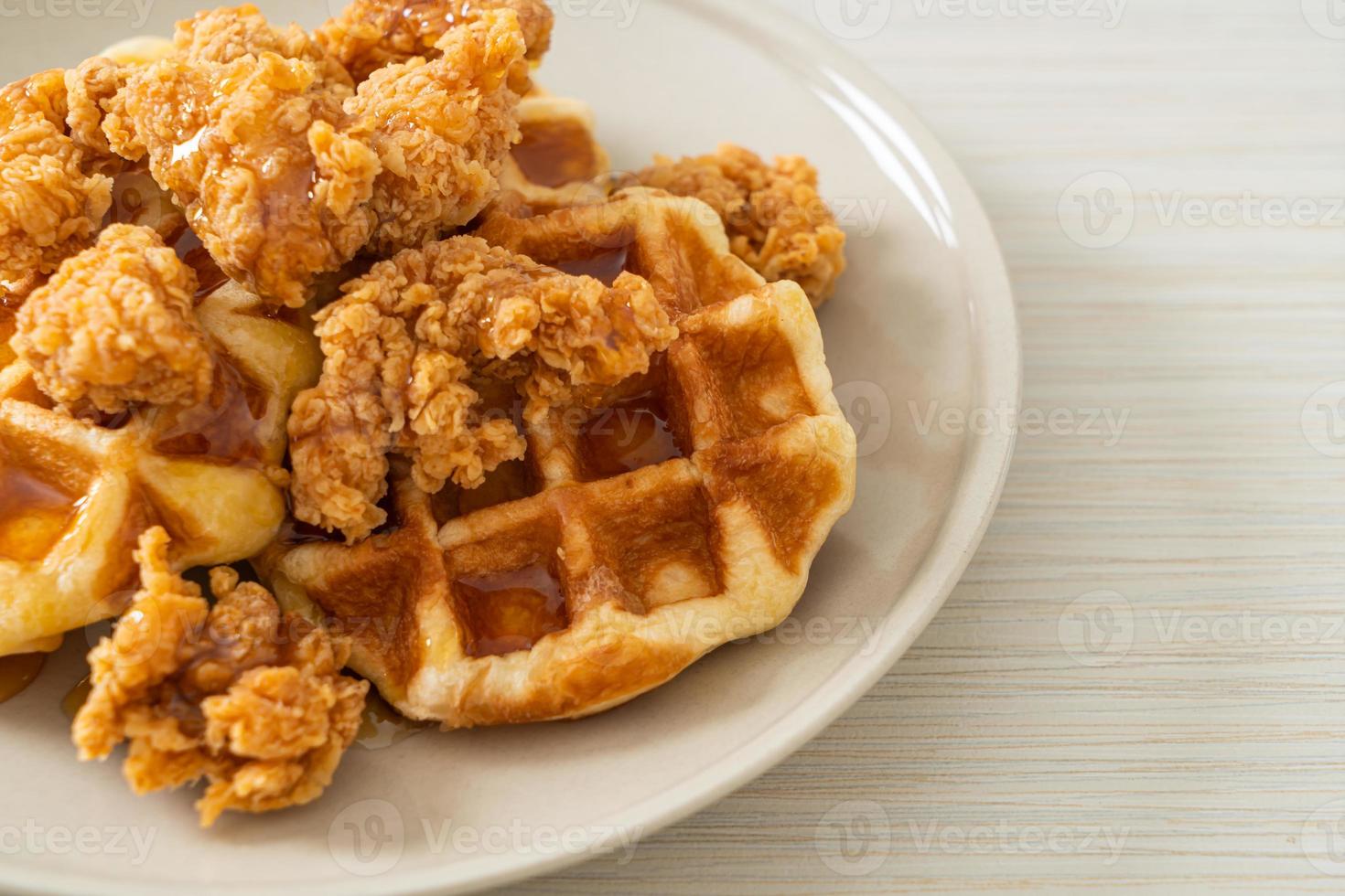 Fried chicken waffle with honey or maple syrup photo