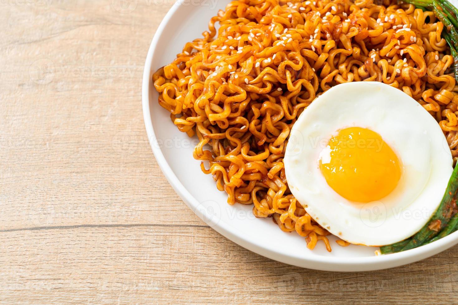 Dried Korean spicy instant noodles with fried egg photo