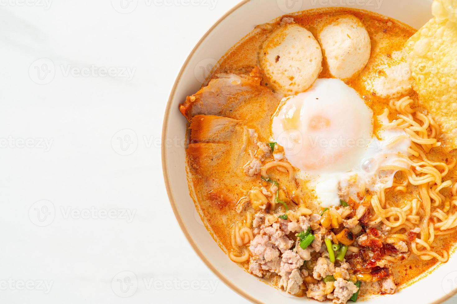 Instant noodles with pork and meatballs in spicy soup photo