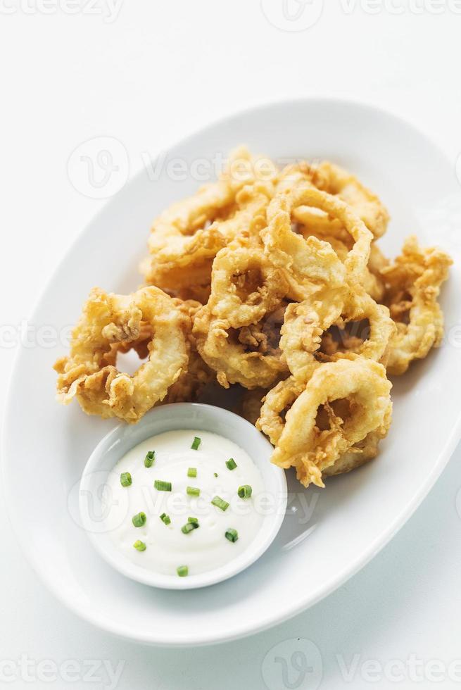 Calamares calamari fired battered squid rings seafood snack with aioli sauce photo