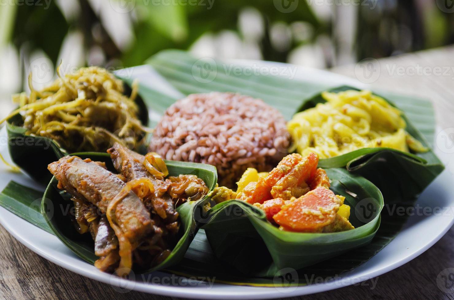 Vegetarian traditional curry and brown rice meal in Bali Indonesia photo